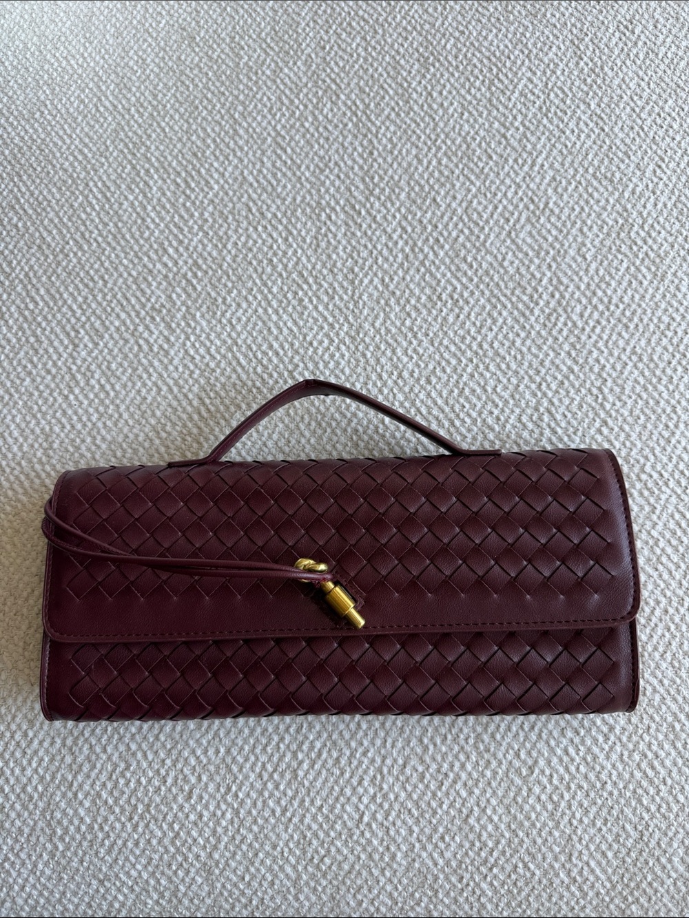 Woven burgundy clutch